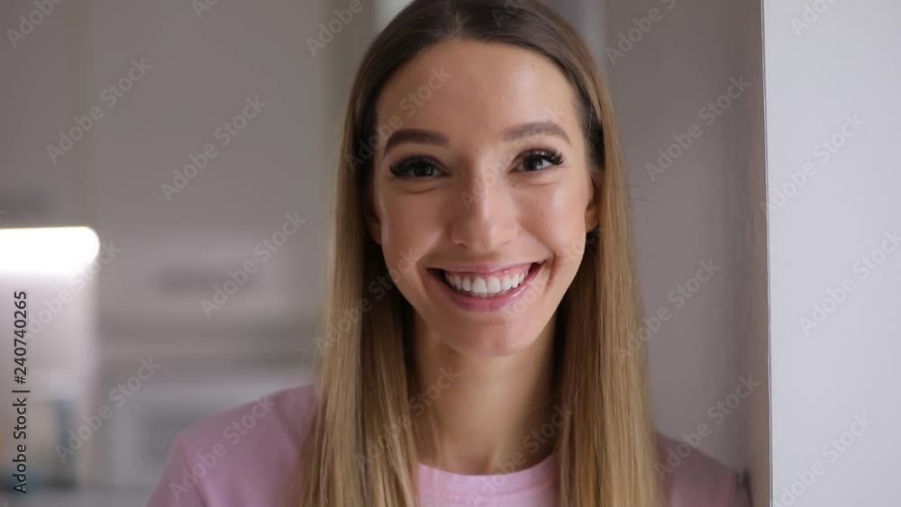 Beautiful cheerful young woman portrait smiling at home closeup Beautiful cheerful young woman portrait smiling at home closeup