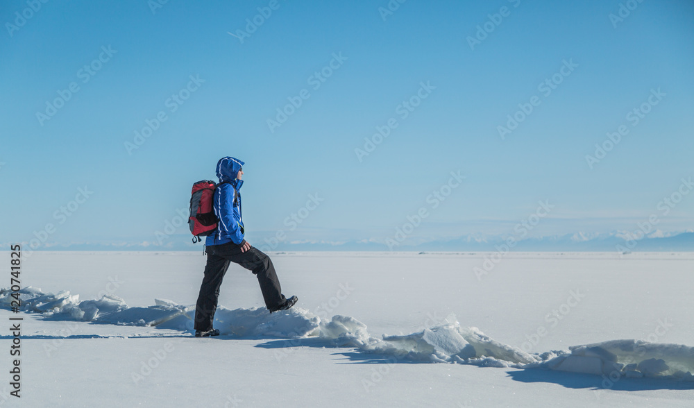 Man hiking on ice. Winter Landscape.