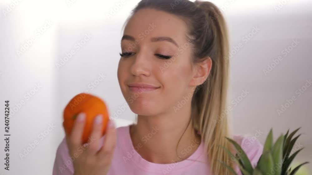 Healthy food, happy woman take, sniff and throw fresh mandarin Healthy food, happy woman take, sniff and throw fresh mandarin