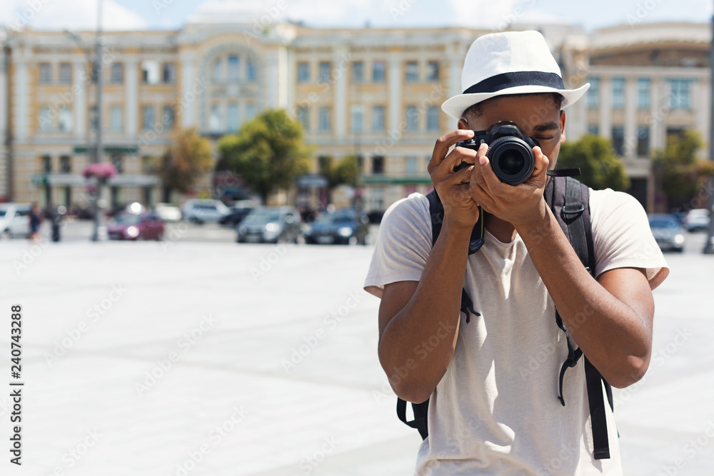African-american man exploring and photographing landmarks in city African-american man exploring and photographing landmarks in city