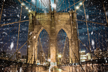 Brooklyn Bridge New York City with snowflakes falling during winter snow storm