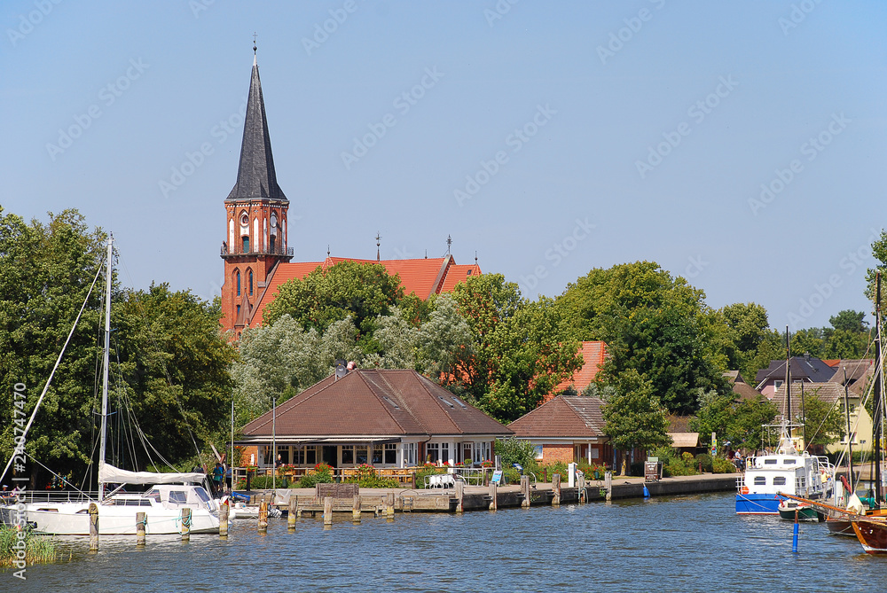 Harbor and church in Wustrow. Wustrow is a municipality at Baltic Sea coast in Mecklenburg-Vorpommern, Fischland, Germany