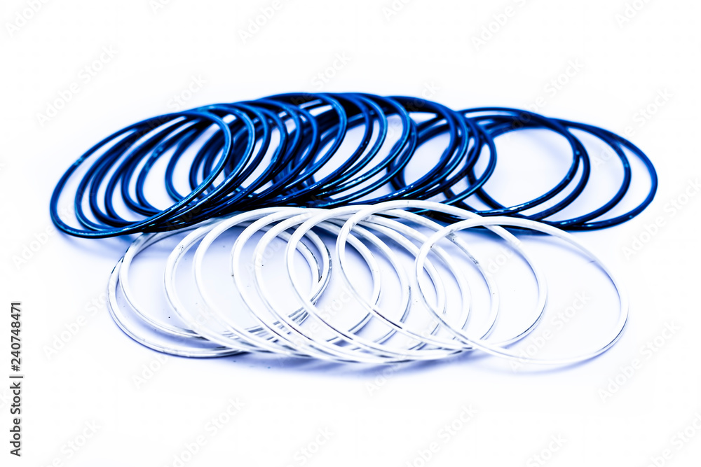 Close up of white and blue colored metal bangles isolated on white. Close up of white and blue colored metal bangles isolated on white.