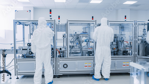 Obraz na płótnie Manufacturing Laboratory where Scientists in Protective Coverall's Work with Industrial High Precision 3D Printing Machinery