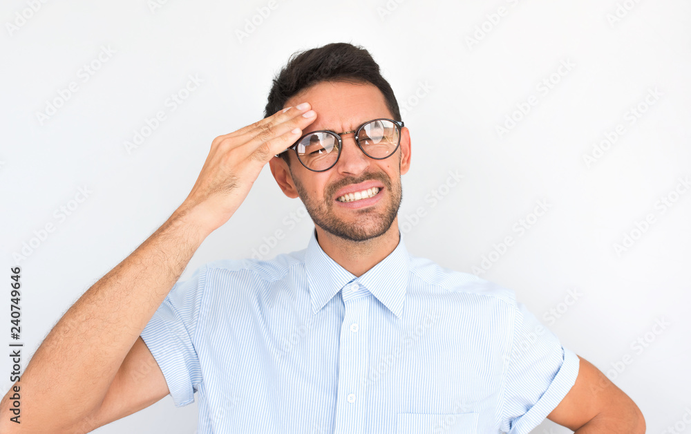 Portrait of unhappy Caucasian man standing with closed eyes wearing spectacles holding hand on head looking stressful. Stressed man suffering from headache. People, health, tension, migraine concept Portrait of unhappy Caucasian man standing with closed eyes wearing spectacles holding hand on head looking stressful. Stressed man suffering from headache. People, health, tension, migraine concept