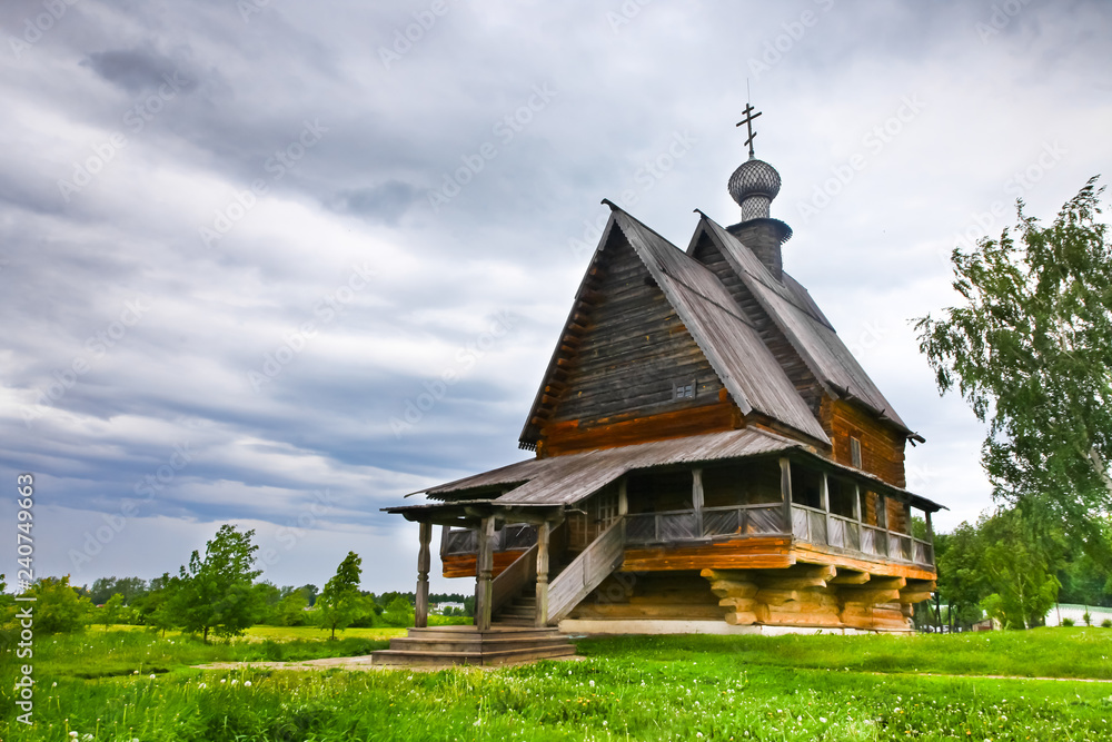 Ancient Russian wooden church under stormy sky Ancient Russian wooden church under stormy sky