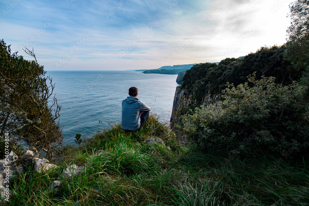 Young caucasian boy looking to the horizon in Asturias, Spain
