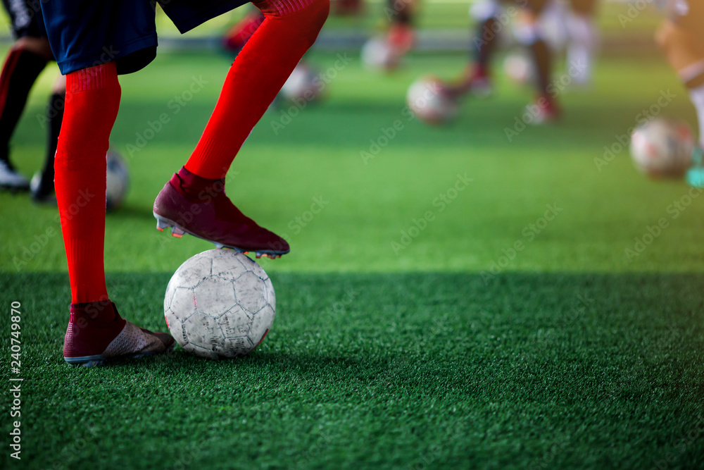 Football player standing and on stepping on the ball Football player standing and on stepping on the ball