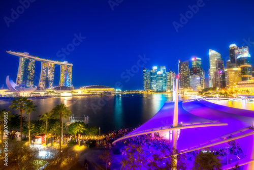 Distant view of Marina Bay Sands and skyscraper in the Central Business Distrcit (CBD) area around the Marina Bay in Singapore during the twilight time. photo