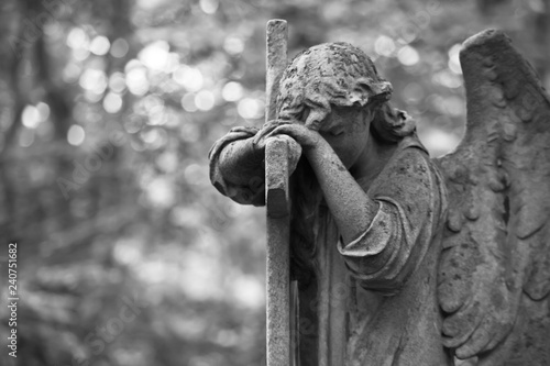 The Sorrowful Angel. Weeping angel with a cross, space for text