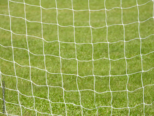 Soccer Goal Net with Green Grass Background with selective focus and crop fragment