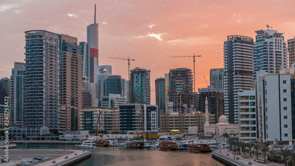 Naklejka premium View of Dubai Marina Towers and canal in Dubai night to day timelapse