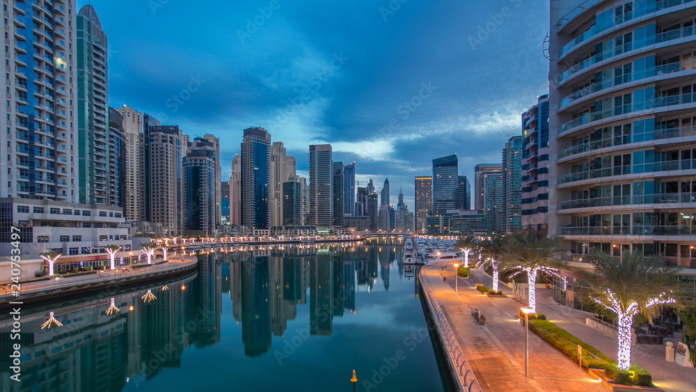 Fototapeta premium View of Dubai Marina Towers and canal in Dubai night to day timelapse