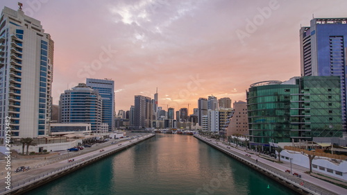 View of Dubai Marina Towers and canal in Dubai night to day timelapse © neiezhmakov