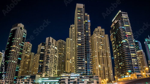 View of Dubai Marina Towers and yahct in Dubai at night timelapse hyperlapse © neiezhmakov