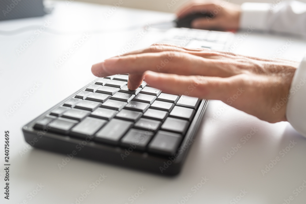 Business programmer using computer keyboard and mouse Business programmer using computer keyboard and mouse