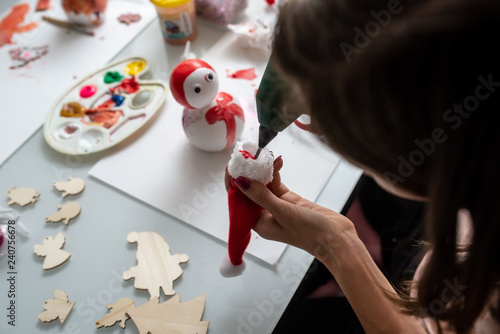 Top view of a woman making Christmas holiday decorations photo