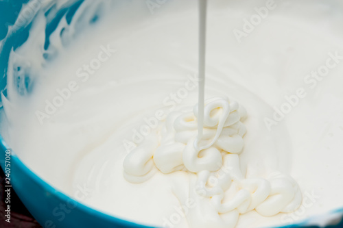 The white cream in the blue plastic bowl