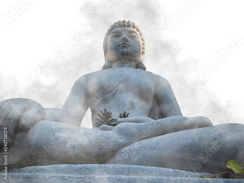 close up stone Head Buddha in gray color mixed with fog background