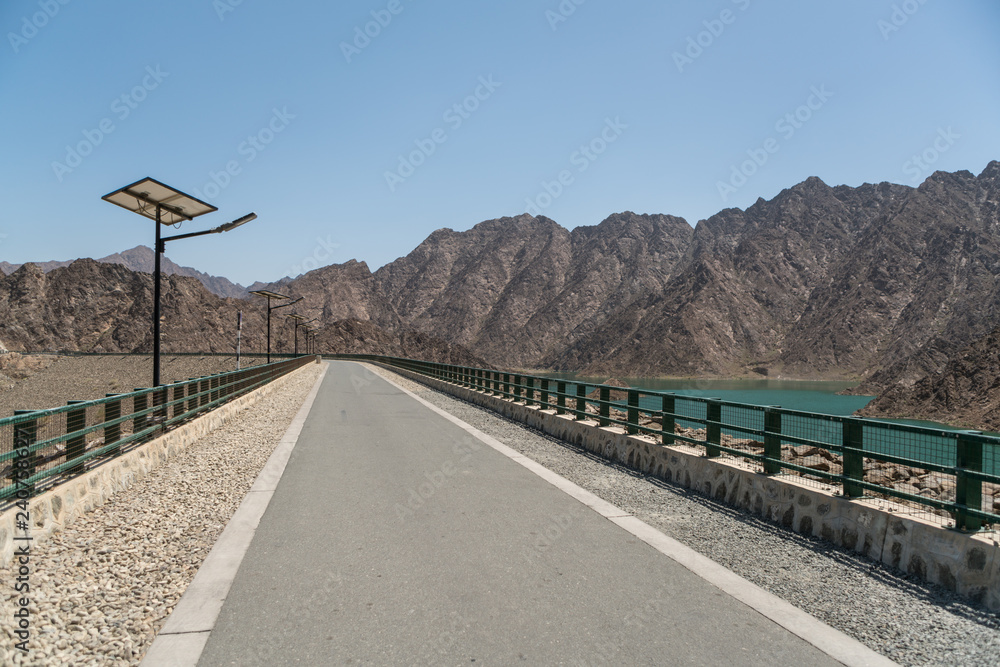 Hatta Dam and reservoir in Hatta, an enclave of the emirate of Dubai in the Hajar Mountains, United Arab Emirates. Hatta Dam and reservoir in Hatta, an enclave of the emirate of Dubai in the Hajar Mountains, United Arab Emirates.