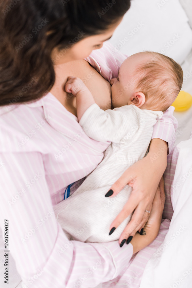 young mother breastfeeding little baby at home young mother breastfeeding little baby at home