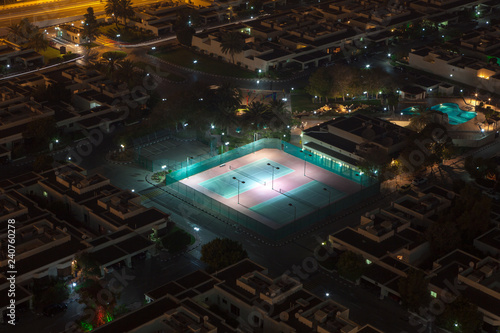 Photography Illuminated tennis courts at Palma Spring Village, Dubai, UAE, in early evening