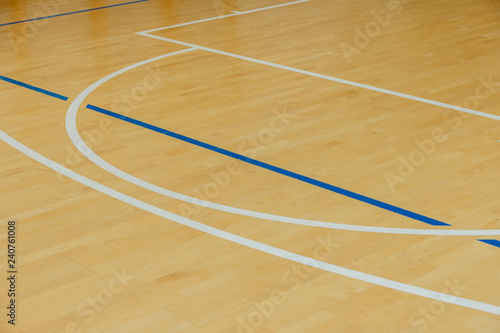 wooden floor volleyball, basketball, badminton, futsal, handball court with light effect Wooden floor of sports hall with marking lines line on wooden floor indoor, gym court © Augustas Cetkauskas