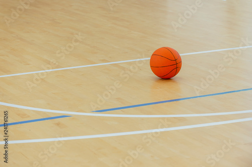 Basketball ball over floor in the gym. Team sport.