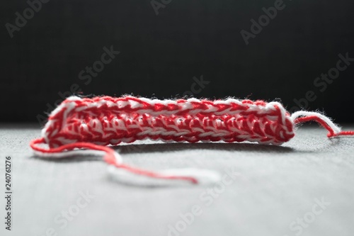 Martenitsa, white and red strains of yarn, Bulgarian folklore tradition, welcoming the spring in March, adornment symbol, wish for good health. Baba Marta Day.  photo