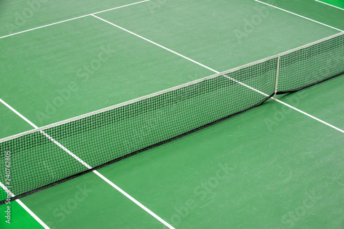 Aerial image of empty outdoor green hard tennis court with nets