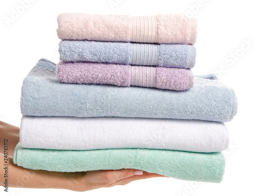 Stack towels whte green blue in hand on white background isolation