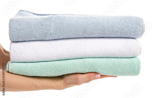 Stack towels whte green blue in hand on white background isolation