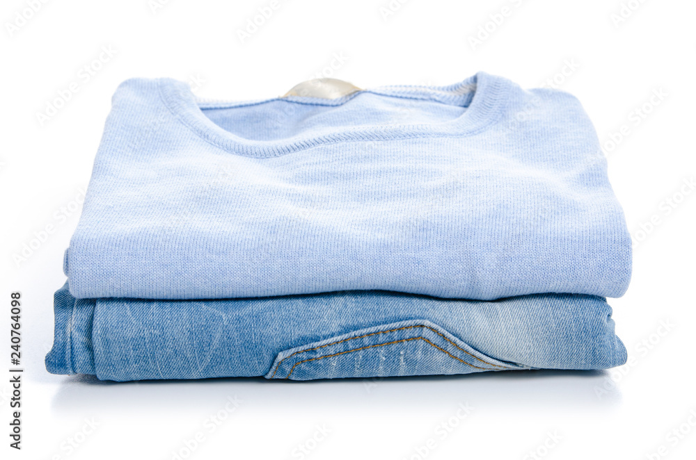 Stack clothing blue jeans and blue sweater on white background isolation 