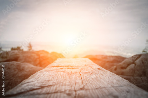 Wooden plank in front of the nature during the sunset.  Table background and spring time