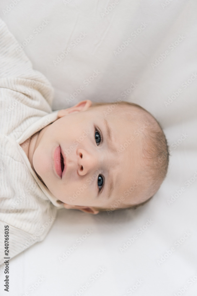 overhead view of adorable baby looking at camera overhead view of adorable baby looking at camera