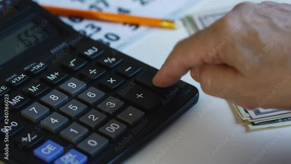 Man Is Counting Money And Using Calculator Man Is Counting Money And Using Calculator