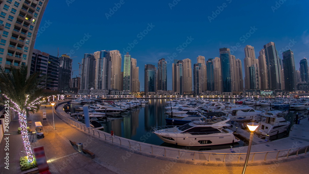 Fototapeta premium Dubai Marina at Blue hour night to day timelapse with yachts