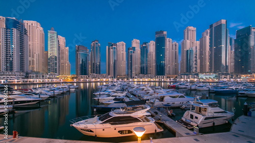 Dubai Marina at Blue hour night to day timelapse with yachts