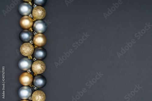Multiple Christmas silver and gold baubles creative decoration pattern with the black background and copy space at the right