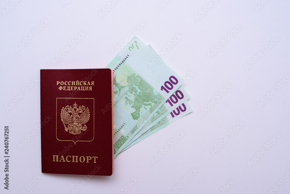Russian international passport with euro in the man's hand. White background Russian international passport with euro in the man's hand. White background