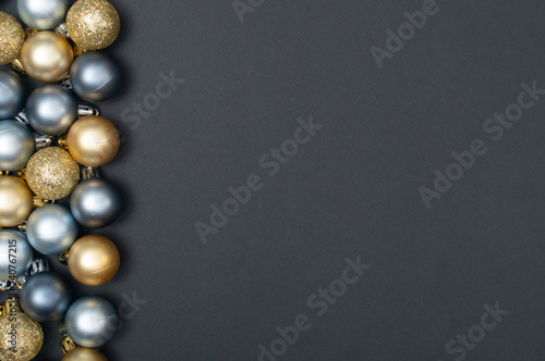 Multiple Christmas silver and gold baubles creative pattern with the black background and copy space