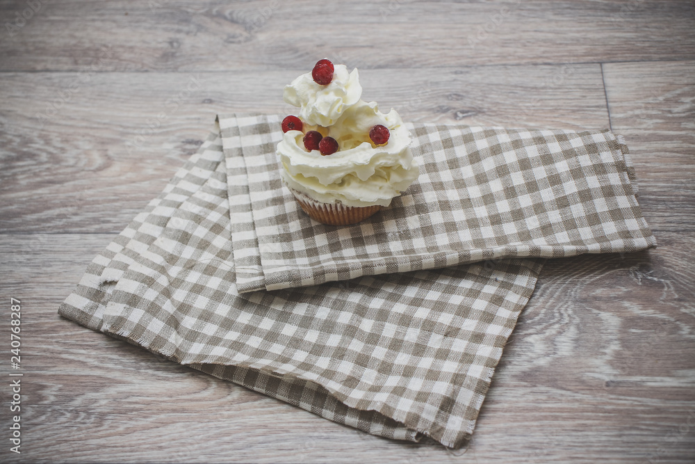Close-up shot with whipped cream, fresh berries on a light checkered linen napkin. Close-up shot with whipped cream, fresh berries on a light checkered linen napkin.