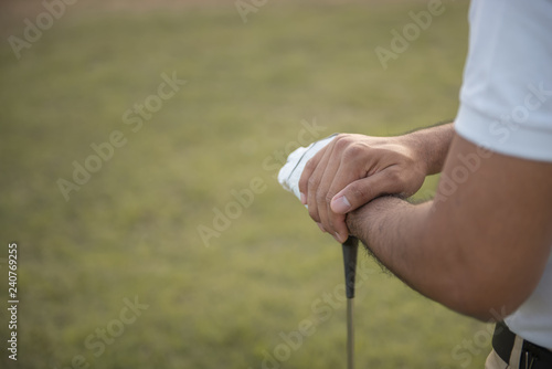 The golfer holding the golf club at the golf course,Thailand people