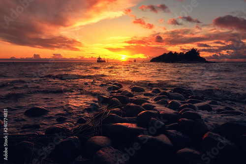 Sea landscape with dramatic sunset and ship on horizon © Margarita