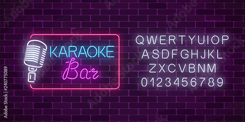 Neon signboard of karaoke music bar with alphabet. Glowing street sign of a nightclub with live music.