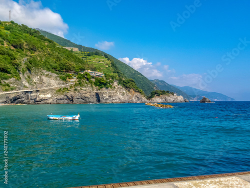 Sea view with a boat  cliffs and mountain hills  bay of Monterosso at Monterosso al Mare  Cinque Terre  Italy