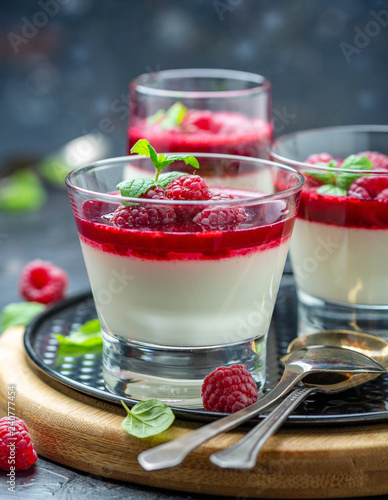 Photos Vanilla Panna cotta with berry sauce and raspberry.