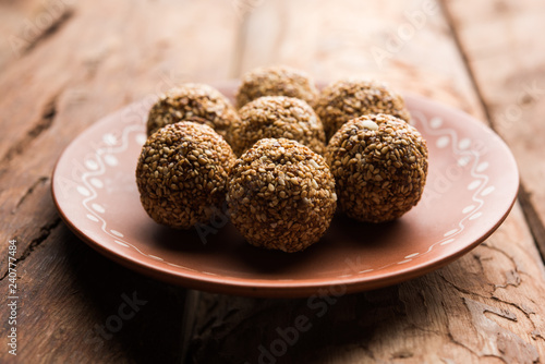 Tilgul Laddu or Til Gul balls for makar sankranti, it's a healthy food made using sesame, crushed peanuts and jaggery. served in a bowl. selective focus showing details. photo