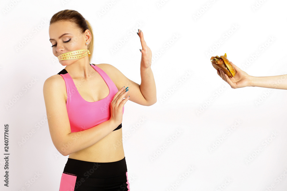 Young girl on a diet refuses burger isolated white background. Young girl on a diet refuses burger isolated white background.