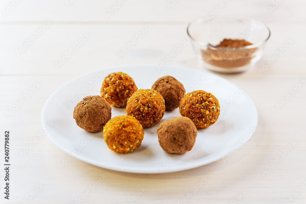 Candy of dried fruits and nuts on a white plate Candy of dried fruits and nuts on a white plate